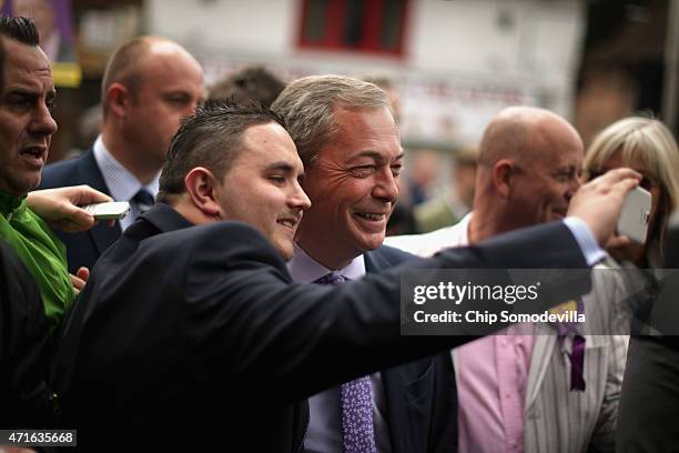 Independence Party leader Nigel Farage pauses for a 'selfie' while campaigning in Market Square on April 30, 2015 in Aylesbury, England. A natural...