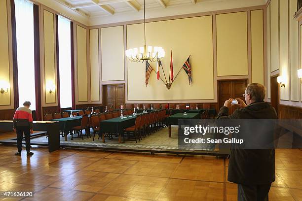 Visitors stand in the original room where on May 8 German military leaders signed a document that finalized Nazi Germany's surrender during World War...