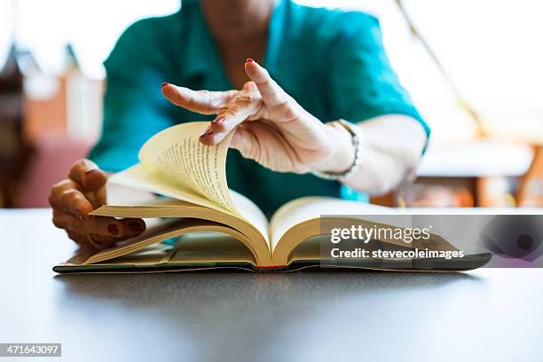 reading book - turning page stock pictures, royalty-free photos & images