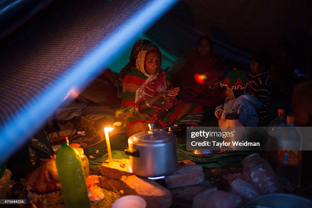 Kathmandu residents displaced by the earthquake spend time...