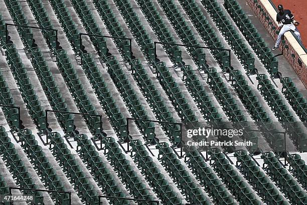 Alexei Ramirez of the Chicago White Sox climbs into the stands before playing the Baltimore Orioles at an empty Oriole Park at Camden Yards on April...