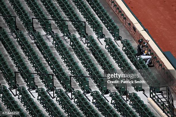 Alexei Ramirez of the Chicago White Sox gestures to teammates with a baseball as he sits in the stands before playing the Baltimore Orioles at an...