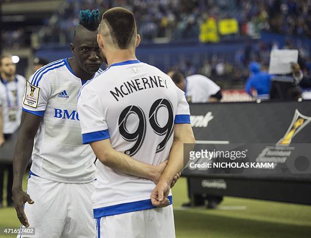 The Montreal Impact's Dominic Oduro exchanges words with teammate Jack McInerney after the Impact's loss in the CONCACAF Champions League return leg...