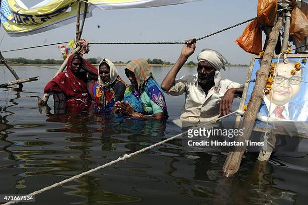 Women too joined the 30-odd farmers in their Jal Satyagraha standing in a waist height water of Omkareshwar dam since April 11 here at Ghogalgaon on...
