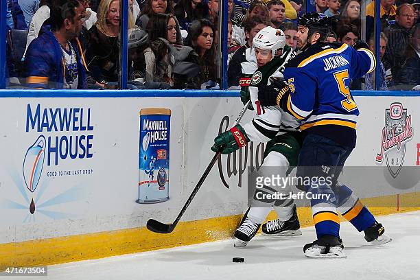 Zach Parise of the Minnesota Wild and Barret Jackman of the St. Louis Blues battle for the puck in Game Two of the Western Conference Quarterfinals...