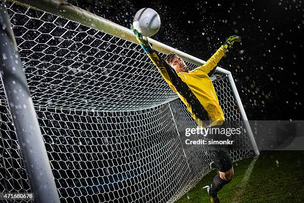 soccer goalie jumping for ball - scoring a goal stock pictures, royalty-free photos & images