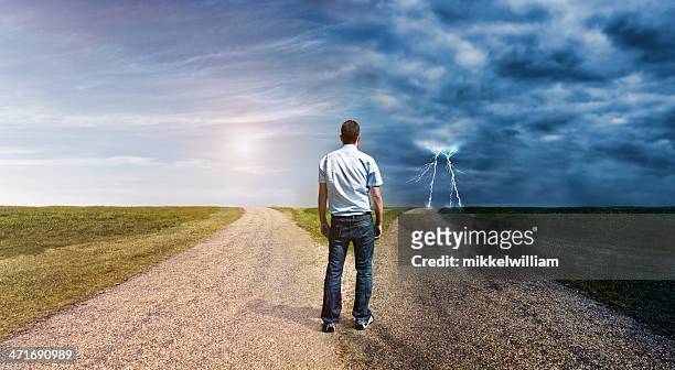 man must decide his way forward to success or failure - road intersection stock pictures, royalty-free photos & images