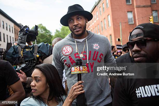 Star Carmelo Anthony of the New York Knicks marches with protesters from the Sandtown neighborhood to City Hall demanding better police...