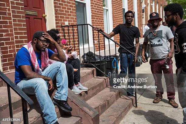 Men hang out on the front stoop of a home in the Sandtown neighborhood where Freddie Gray was arrested on April 30, 2015 in Baltimore, Maryland. Gray...