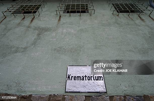 Windows of cells used by Gestapo are pictured above a sign for the crematorium of former Nazi concentration camp Mauthausen, northern Austria on...