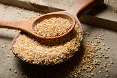 A picture of grains in a wooden spoon
