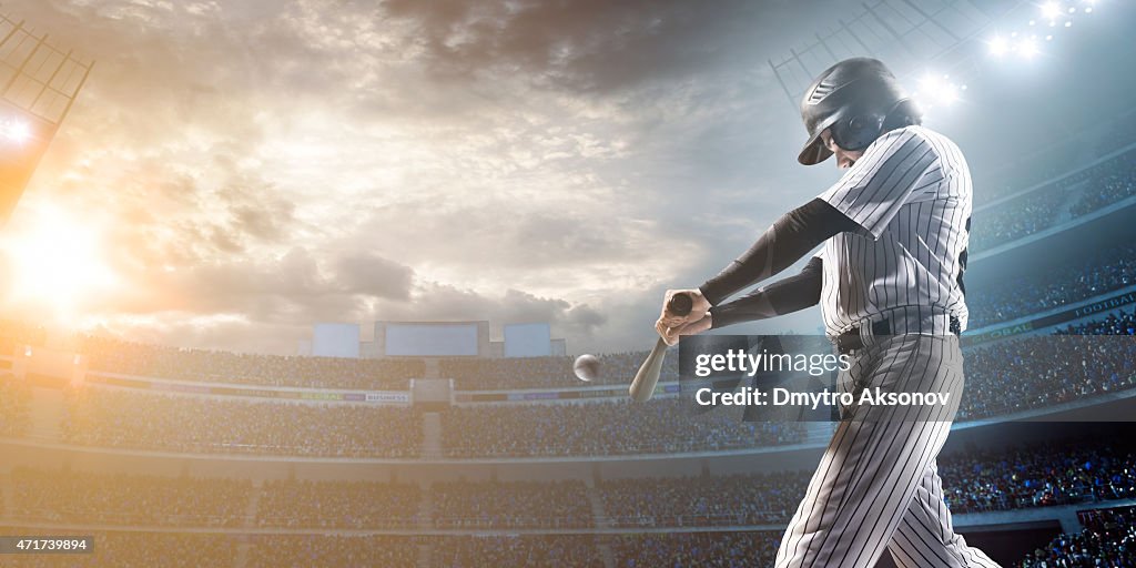 Baseball player hitting a ball in stadium