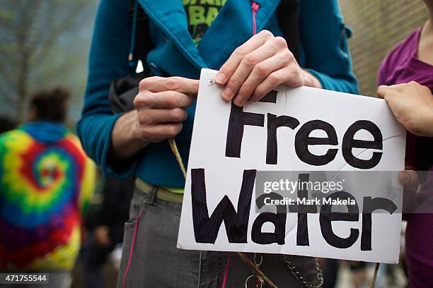 Protestors adjust a "free water" sign during a demonstration over the death of Freddie Gray on April 30, 2015 in Philadelphia, Pennsylvania. Freddie...