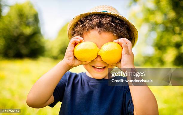 happy boy with lemons smiling as vitamin c concept - lemon fruit stockfoto's en -beelden