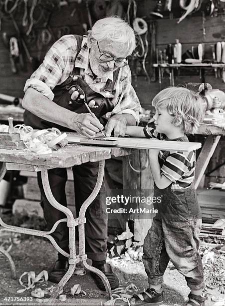 grandfather and grandson in workshop - woodshop stock pictures, royalty-free photos & images
