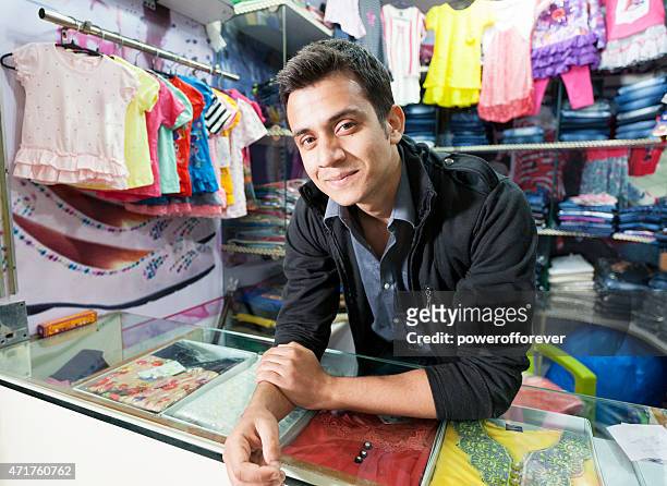 young man selling clothes at a shopping mall - indian shopkeeper stock pictures, royalty-free photos & images