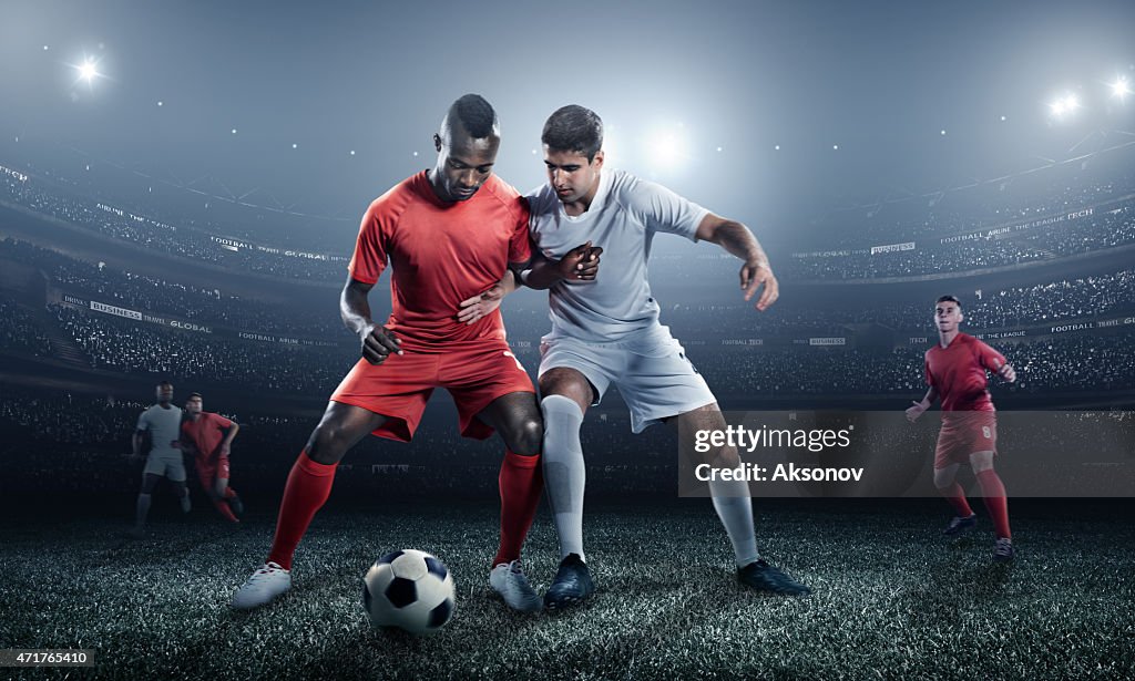 Soccer player kicking ball in stadium