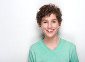 Happy young boy with curly hair smiling