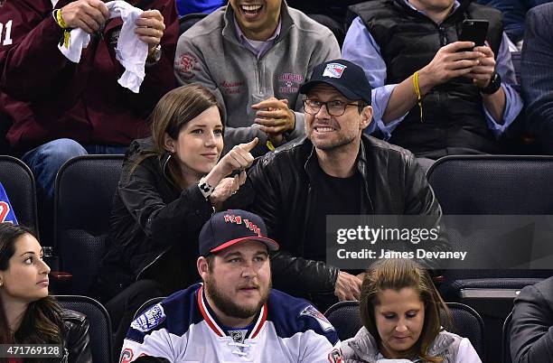 Brittany Lopez and Christian Slater attend the Washington Capitals vs New York Rangers playoff game at Madison Square Garden on April 30, 2015 in New...
