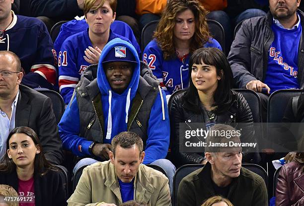 Michael Che and guest attend the Washington Capitals vs New York Rangers playoff game at Madison Square Garden on April 30, 2015 in New York City.