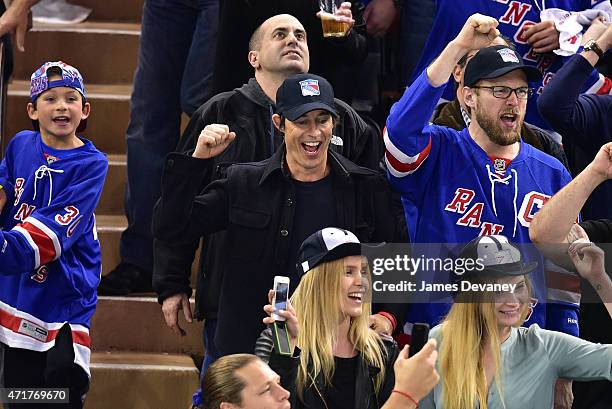 Tom Cavanagh and guest attend the Washington Capitals vs New York Rangers playoff game at Madison Square Garden on April 30, 2015 in New York City.