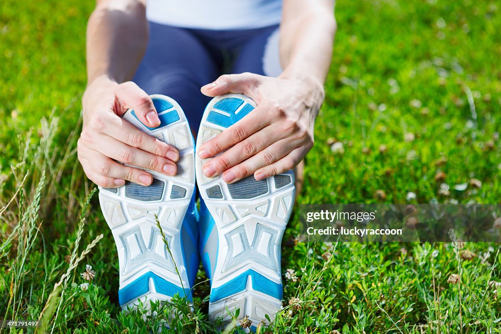 Young woman stretching before exersise - closeup shot.