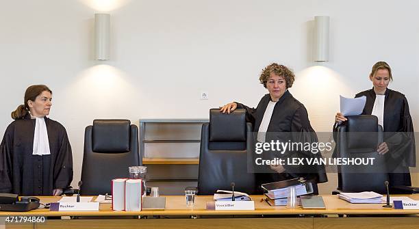 Judge M.E.H Janssen, chairperson N van der Ploeg-Hogervorst and judge T van de Poll take their seats during the court case of German nationals who...