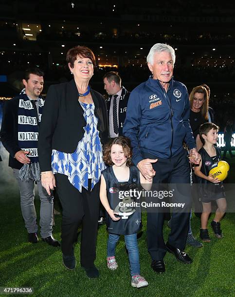 Michael Malthouse the coach of the Blues walks out onto the field with his grandchildren during the round five AFL match between the Carlton Blues...