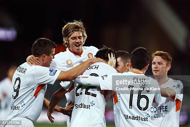 Thomas Broich of Brisbane Roar is congratulated by teammates after scoring a goal during the A-League Elimination Final match between Adelaide United...