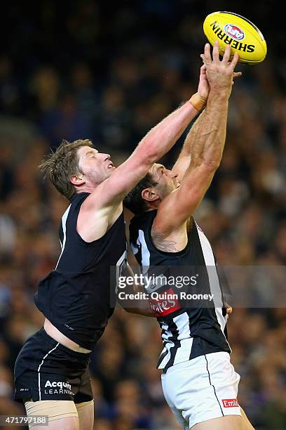 Travis Cloke of the Magpies marks infront of Sam Rowe of the Blues during the round five AFL match between the Carlton Blues and the Collingwood...