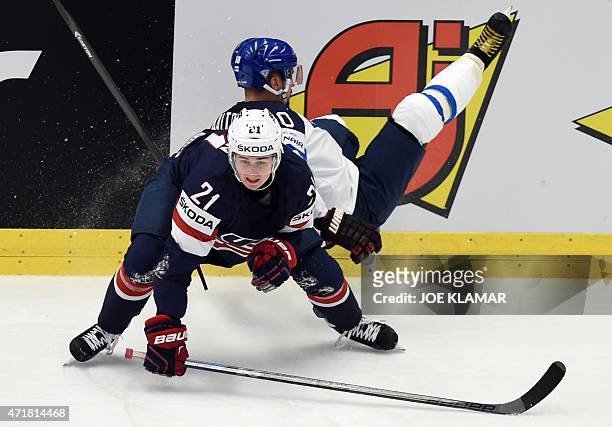 Finland's Juhamatti Aaltonen and Dylan Larkin of US fight for the puck during the group B preliminary round ice hockey match USA vs Finland of the...