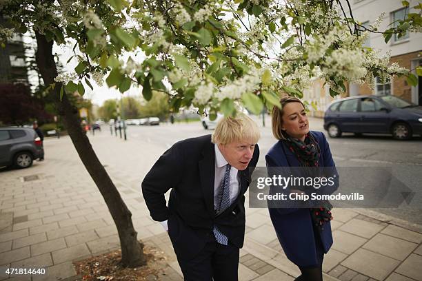 London Mayor Boris Johnson ducks below tree branches while being interviewed by the BBC's Newsnight Chief Correspondent Laura Kuenssberg in between...