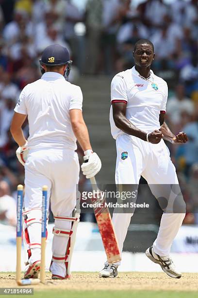 Jason Holder of West Indies celebrates bowling Gary Ballance of England during day one of the 3rd Test match between West Indies and England at...