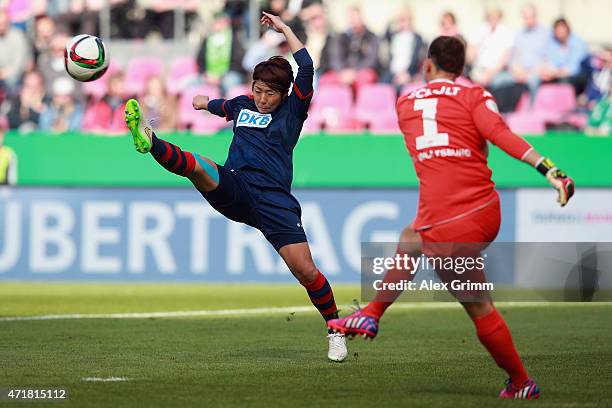 Goalkeeper Almuth Schult of Wolfsburg is challenged by Asano Nagasato of Potsdam during the Women's DFB Cup Final between Turbine Potsdam and VfL...