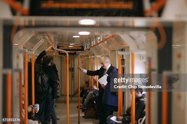 London Mayor Boris Johnson rides an Overground train in between campaingn stops with Conservative candidates on May 1, 2015 in London, United...
