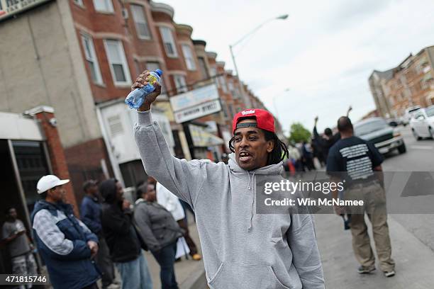 Man gestures in the street after Baltimore authorities released a report on the death of Freddie Gray on May 1, 2015 in Baltimore, Maryland. Marilyn...