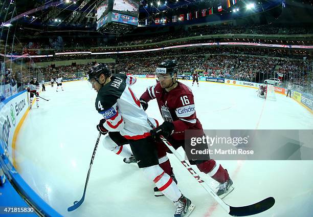 Taylor Hall of Canada and Kaspars Daugavins of Latvia battle for the puck during the IIHF World Championship group A match between Canada and Latvia...