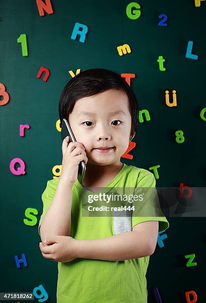 boy using smart phone - number magnet stock pictures, royalty-free photos & images