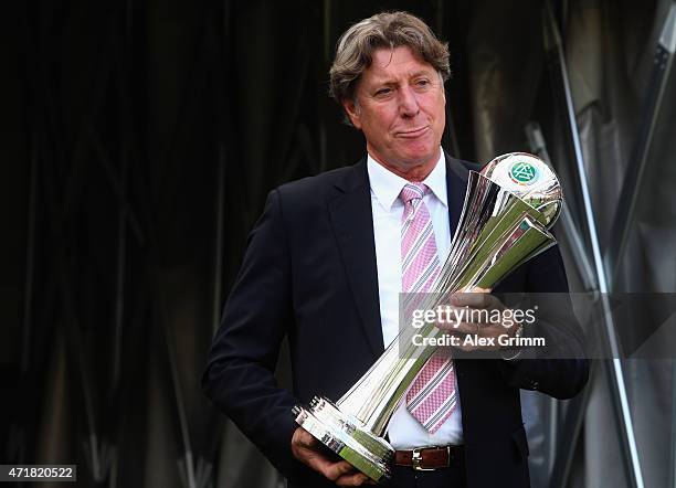 Harald Schumacher carries the trophy prior to the Women's DFB Cup Final between Turbine Potsdam and VfL Wolfsburg at RheinEnergieStadion on May 1,...