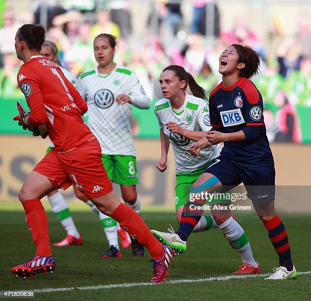 Goalkeeper Almuth Schult of Wolfsburg holds the ball as Asano Nagasato of Potsdam reacts during the Women's DFB Cup Final between Turbine Potsdam and...