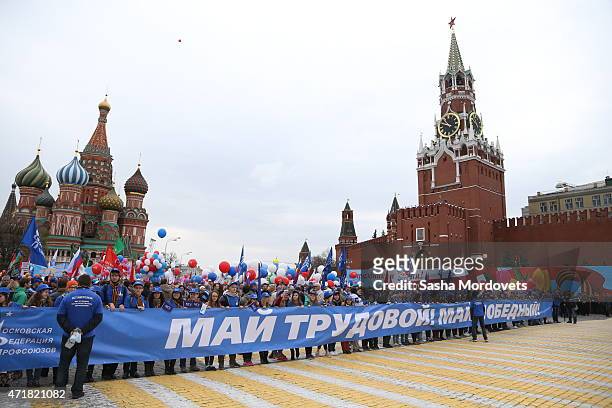 People celebrate with flags, balloons, music, dance and anti-U.S. Posters on Red Square during a Soviet style rally of Russian trade unions on May 1,...