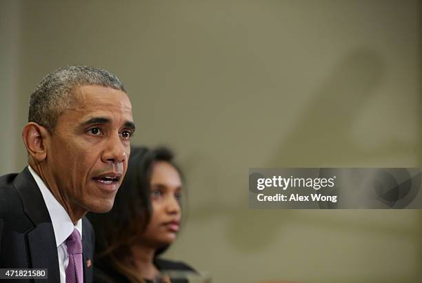 President Barack Obama speaks as Simegnish "Lily" Mengesha2nd L) of Ethiopia listens during a roundtable with persecuted journalists at the Roosevelt...