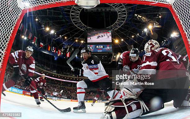 Taylor Hall of Canada fails to score over Edgars Masalskis , goaltender of Latvia battle for the puck during the IIHF World Championship group A...