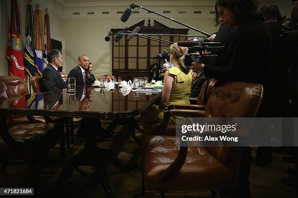 President Barack Obama speaks as Nguyen Van Hai , better known by his pen name Dieu Cay, of Vietnam, and Simegnish "Lily" Mengesha of Ethiopia listen...