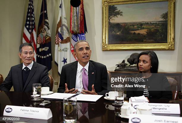 President Barack Obama speaks as Nguyen Van Hai , better known by his pen name Dieu Cay, of Vietnam, and Simegnish "Lily" Mengesha of Ethiopia listen...