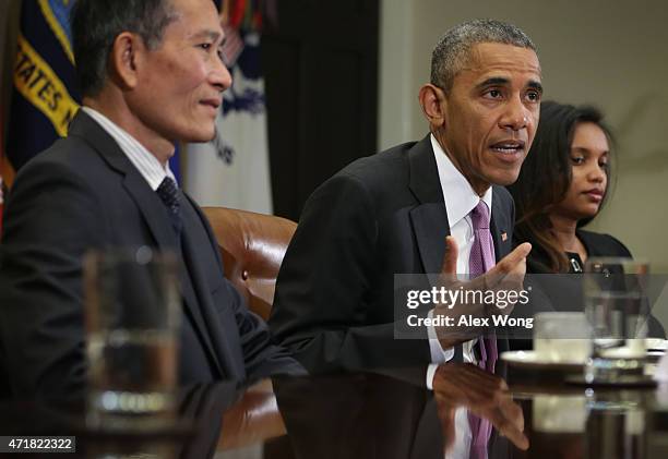 President Barack Obama speaks as Nguyen Van Hai , better known by his pen name Dieu Cay, of Vietnam, and Simegnish "Lily" Mengesha of Ethiopia listen...