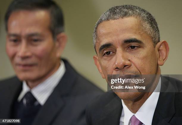 President Barack Obama speaks as Nguyen Van Hai , better known by his pen name Dieu Cay, of Vietnam, listens during a roundtable with persecuted...