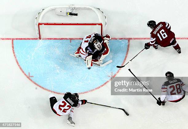 Mike Smith, goaltender of Canada stops the shot of Kaspars Daugavins of Latvia during the IIHF World Championship group A match between Canada and...