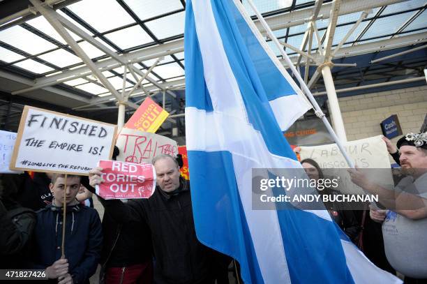 Anti-Labour Party protesters demonstrate in front of Labour Party activists outside the Tollcross Sports Centre in Glasgow on May 1, 2015 where...