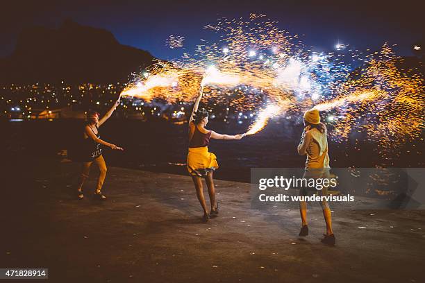 teen grunge girls dancing with firework flares at night - nödraket bildbanksfoton och bilder